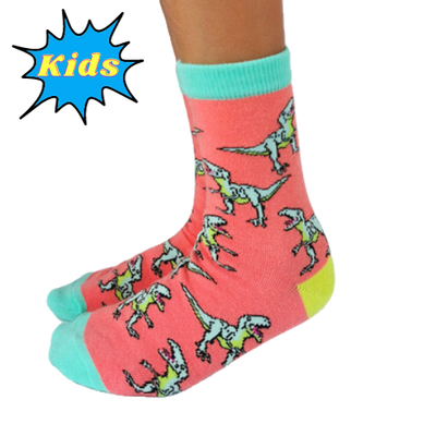 CLASSIC JURASSIC SOCKS - KIDS'. Pink background with t-rex pattern all over the socks. Teal toes and top of socks with lime green heal.