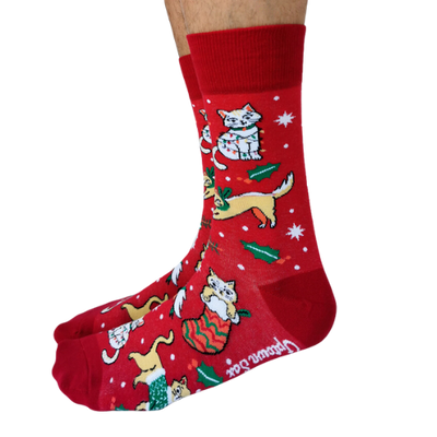 Red festive socks featuring playful holiday-themed cats, gifts, and holly designs