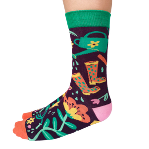 Women's crew socks with colorful gardening-themed designs including flowers, boots, and a watering can from Uptown Sox.