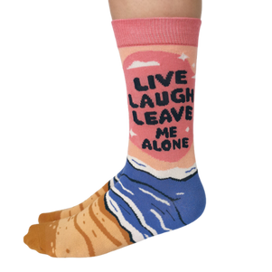 Women's crew socks with the phrase 'Live Laugh Leave Me Alone' in bold lettering and a colorful beach-themed design from Uptown Sox.
