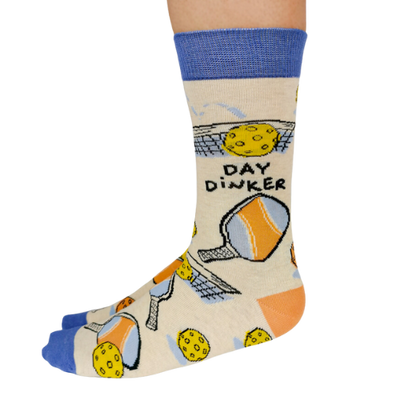 Pickleball-themed socks with vibrant patterns, perfect for players, featuring paddles and balls from Uptown Sox.
