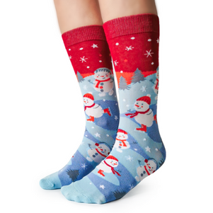 The sock bar skating snowman socks by Uptown Sox. Red and blue socks with a winter scene with skating snowman